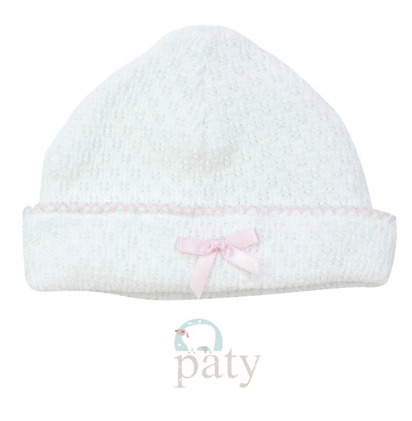 White hat with pink trim and bow